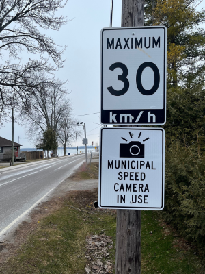 Sign stating Municipal Speed camera in use and a sign stating maximum 30 KM/hour