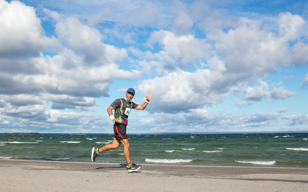 marathon runner on shore of Lake Simcoe